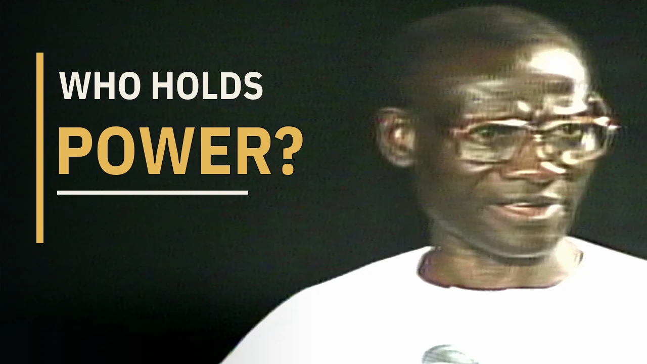 Chief Melford Okilo speaking, with the words Who Holds Power?